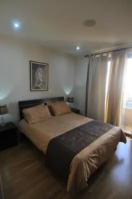 a bedroom with a large bed and a window at Ithaki Phinikoudes Apartment No. 204 in Larnaka