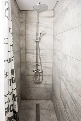 a bathroom with a shower with a shower curtain at Hubstay - Klea's Downtown City Apartment Suite in Larnaka