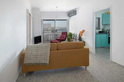 a living room with a couch and a kitchen at Amazing Sea View and Location in Scala