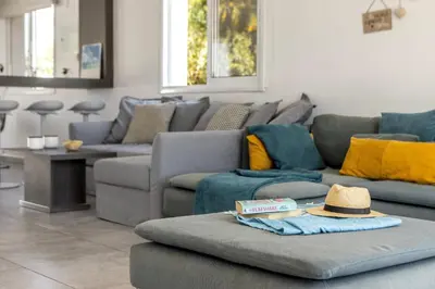a living room with couches and a hat on a couch at Ayia Napa Bay View Villa 5 in Ayia Napa