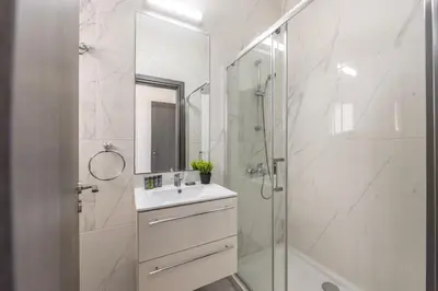 a white bathroom with a sink and a shower at Ayia Napa Bay View Villa 5 in Ayia Napa