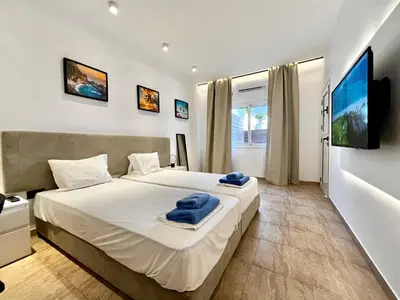 a bedroom with a large bed with blue towels on it at STAY Napa Velvet Apartment in Ayia Napa