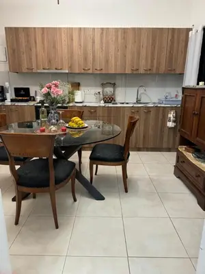 a kitchen with a table and some chairs and a table at Διαμέρισμα ισόγειο για ενοικίαση in Limassol