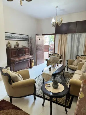 a living room with a couch and a piano at Διαμέρισμα ισόγειο για ενοικίαση in Limassol
