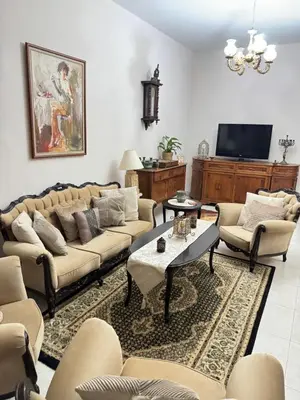 a living room with couches and a tv at Διαμέρισμα ισόγειο για ενοικίαση in Limassol
