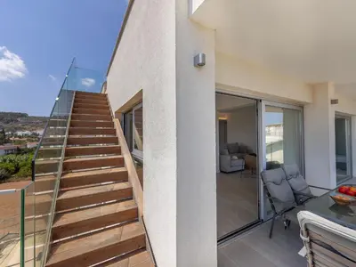 a staircase leading up to a house at Emerald Bay Sea-Front Penthouse in Protaras