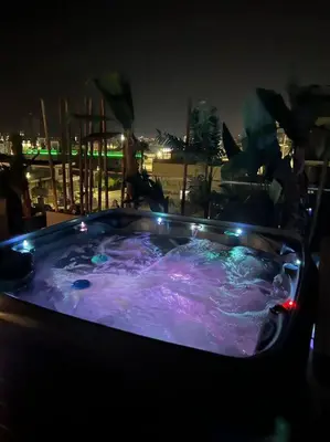 a jacuzzi tub at night with lights on it at 3 Br Penthouse Jacuzzi Seaview in Limassol