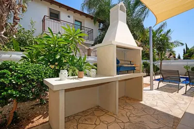 a outdoor kitchen with a stove in a yard at Villa Evia - Walking to Med Sea in Ayia Napa