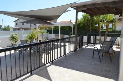 a patio with tables and chairs and umbrellas at Ayia Napa Marina Luxury Villas - Pearl in Ayia Napa