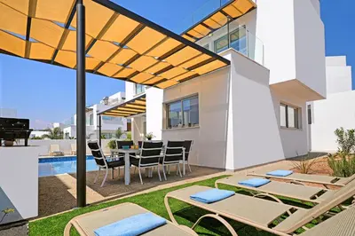 a villa with a swimming pool and a patio at Villa Rosaleen - Ayia Napa Resort Center in Ayia Napa