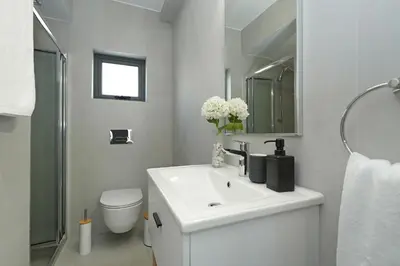 a white bathroom with a sink and a toilet at Villa Merope - 3Bed All En-suite in Paralimni