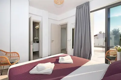 a bedroom with a bed with two towels on it at Villa Merope - 3Bed All En-suite in Paralimni