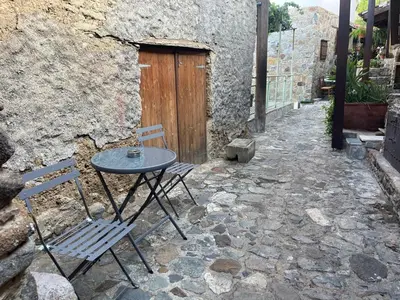 a table and chairs sitting in front of a building at House No9 - Studio in Kakopetria