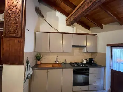 a kitchen with white cabinets and a stove top oven at House No9 - Studio in Kakopetria