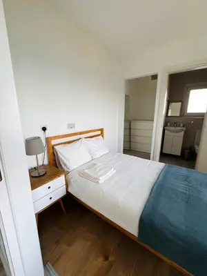 a bedroom with a large white bed and a nightstand at Sea view 3 bedrooms apartment in Limassol