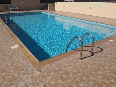 a large swimming pool with blue water at Star Apt in front Nissi whit Sea View in Ayia Napa
