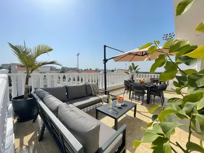 a patio with a couch and a table on a balcony at Star Apt in front Nissi whit Sea View in Ayia Napa