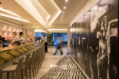 a restaurant with a bar with a black and white picture on the wall at Nicosia 360 Luxury Living A in Nicosia