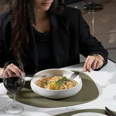 a woman sitting at a table with a bowl of food at Nicosia 360 Luxury Living A in Nicosia