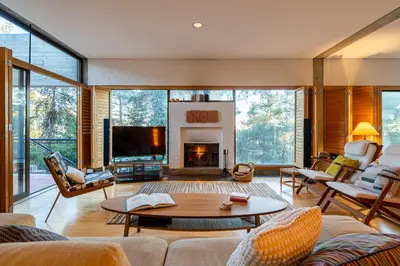 a living room with a table and a fireplace at Paradise Peek, Platres in Platres