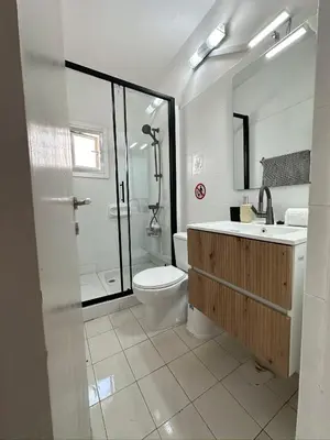 a bathroom with a toilet and a sink and a shower at Sea and Lake Breeze 1BR Apt in Larnaka