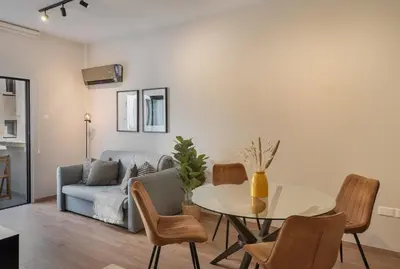 a living room with a table and a couch at Phaedrus Living Larnaca Tsimintia Retreat in Larnaka