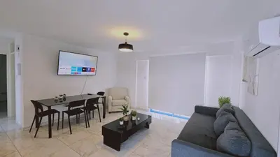 a living room with a couch and a table at STAY Chrisoula Beach Garden in Voroklini