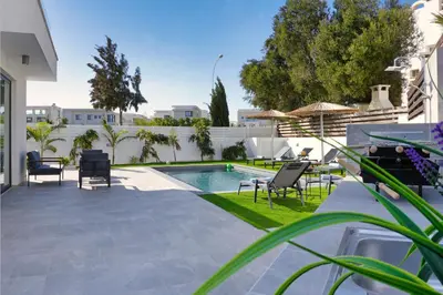 a patio with chairs and a swimming pool at Villa Vitalia - 3 En-suite Beds with Private Pool in Paralimni
