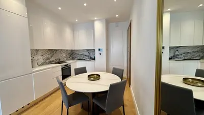 a kitchen with a table and chairs in a room at Oxford House Apt by TrulyCyprus in Limassol