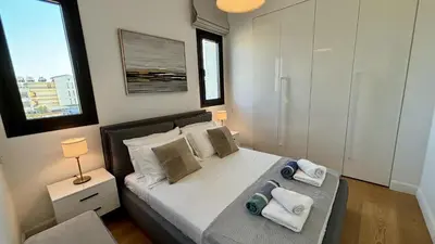 a bedroom with a bed with towels on it at Oxford House Apt by TrulyCyprus in Limassol