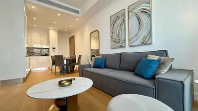 a living room with a couch and a table at Oxford House Apt by TrulyCyprus in Limassol