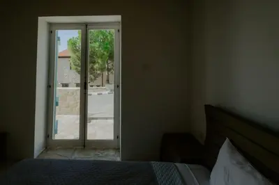 a bedroom with a bed and a sliding glass door at Dipaton House in Vasa 1 in Limassol
