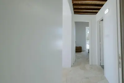 a hallway with white walls and a wooden ceiling at Dipaton House in Vasa 1 in Limassol