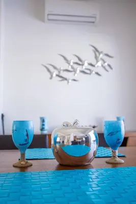 a table with three wine glasses and a bowl on it at Hubstay - Blue Harmony Villa in Protaras - 5 min Walk to the Beach in Paralimni