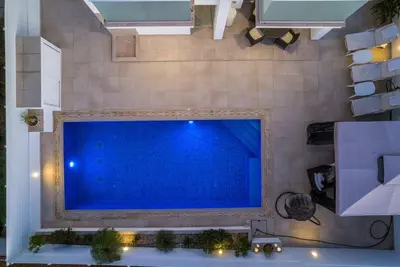 a large blue screen tv on a wall at Hubstay - Blue Harmony Villa in Protaras - 5 min Walk to the Beach in Paralimni