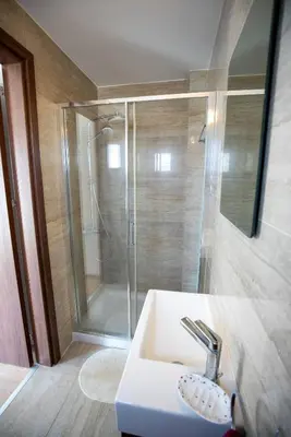 a bathroom with a shower and a white sink at Hubstay - Blue Harmony Villa in Protaras - 5 min Walk to the Beach in Paralimni