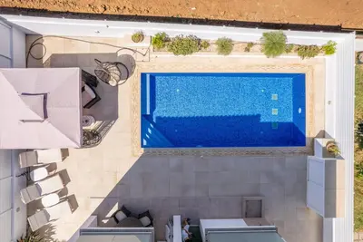 an overhead view of a swimming pool in a house at Hubstay - Blue Harmony Villa in Protaras - 5 min Walk to the Beach in Paralimni