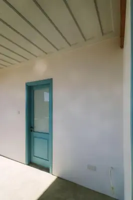 a room with a blue door in a white wall at Dipaton House in Vasa 2 in Vasa Kilaniou