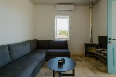 a living room with a couch and a table at Dipaton House in Vasa 2 in Vasa Kilaniou