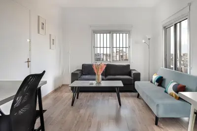 a living room with a couch and a table at Phaedrus Living Larnaca Harbour Heights in Larnaka