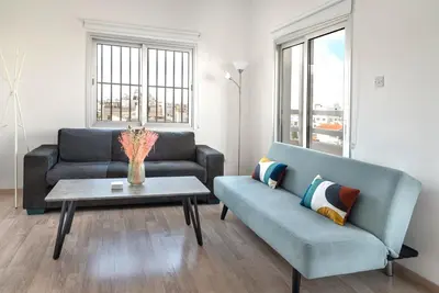 a living room with a couch and a table at Phaedrus Living Larnaca Harbour Heights in Larnaka