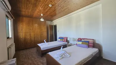 a bedroom with two beds and a wooden ceiling at STAY Uptown Apartment in Engomi
