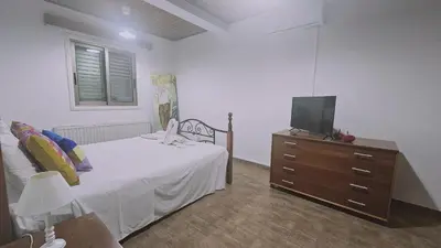 a bedroom with a bed and a tv on a dresser at STAY Uptown Apartment in Engomi
