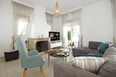 a living room with a couch and a table at Villa Alyson in Paralimni