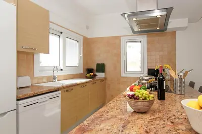 a kitchen with a counter top with a bowl of fruit at Villa Alyson in Paralimni