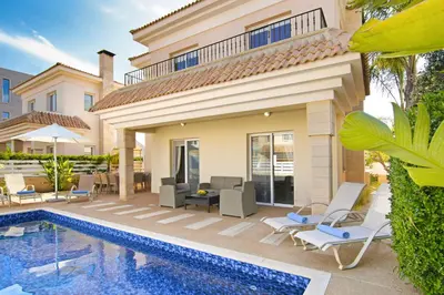a villa with a swimming pool and a house at Villa Alyson in Paralimni