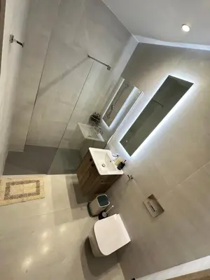 a bathroom with a sink and a shower and a toilet at Joanna & Arya Central Engomi Apts in Nicosia