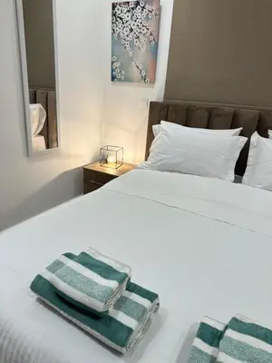 a bedroom with two towels on a bed at Joanna & Arya Central Engomi Apts in Nicosia