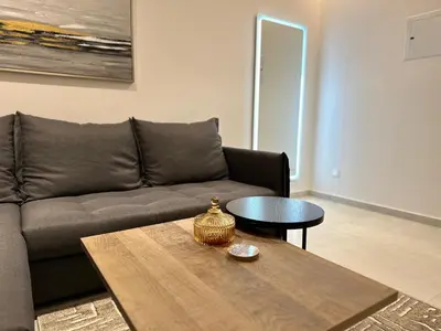a living room with a couch and a table at Joanna & Arya Central Engomi Apts in Nicosia