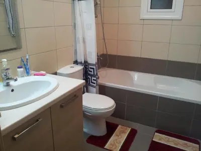 a bathroom with a sink and a toilet and a bath tub at Mazotos Panoramic Village in Mazotos
